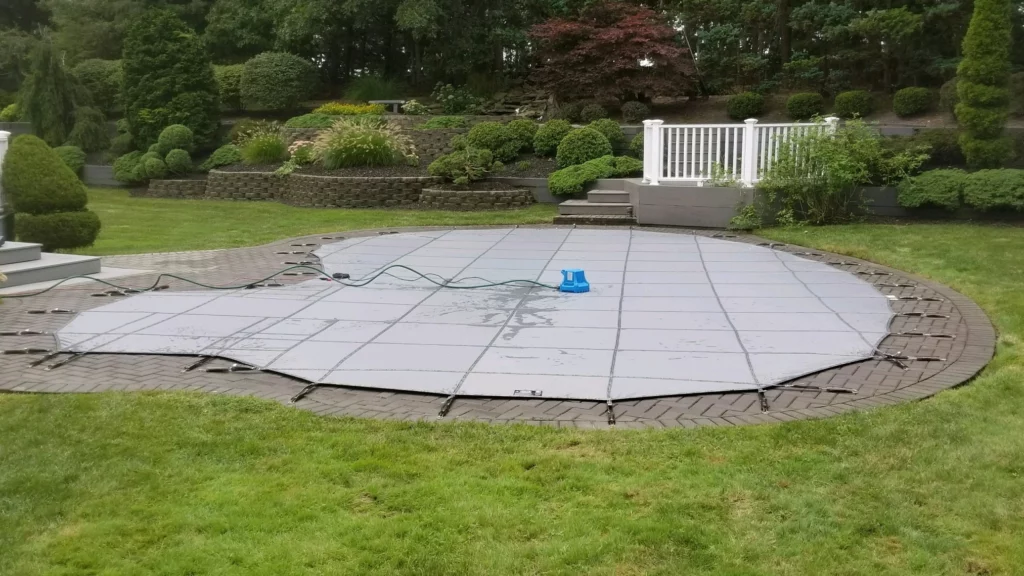 Gray ultra loc solid cover without drain panels and an automatic cover pump