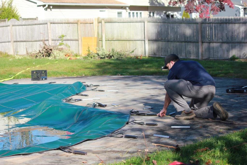 Romanelli Pools Technician Working on Safety Cover installation